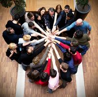 group of people joining hands as a team