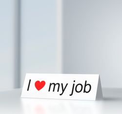 an image of a desk note saying I love my job