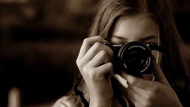 female photographer holding a camera